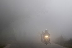 Rain ends days of thick haze in Palembang