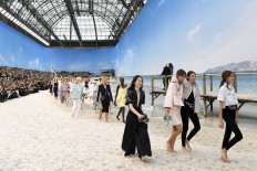 Lagerfeld takes Chanel to beach as Vuitton boosts color