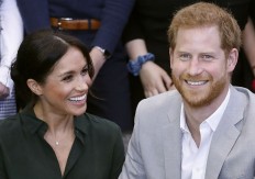 Britain's Prince Harry, Duke of Sussex (R) and Britain's Meghan, Duchess of Sussex (L) on a visit to Joff Youth Centre in Peacehaven in East Sussex, southern England, on October 3, 2018. 