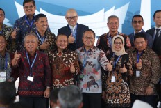 Members of state-owned enterprises and investors involved in projects worth US$13.5 billion pose for a photograph after signing documents in Nusa Dua, Bali, on Thursday on the sidelines of the 2018 Annual Meetings of the International Monetary Fund and World Bank Group.