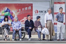 Chinese elderly at a bus stop in Shanghai, China, in June 2013. 