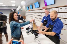 The first customer to legally purchase cannabis is handed a sealed bag containing products at a Nova Scotia Liquor Corp. store in Halifax, Nova Scotia, Canada, on Wednesday. 