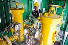 An employee checks a meter regulator station at a gas pipeline facility in Probolinggo, East Java, in this undated photo. 