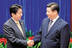 Xi Jinping (right) told Shinzo Abe that China and Japan were important neighbours, and said the healthy development of ties was of importance to the rest of the world. 