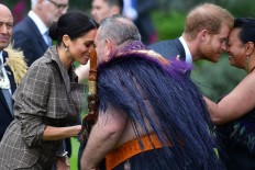 Britain's Prince Harry (2nd R) and his wife Meghan (L), the Duchess of Sussex, receive a 'hongi', or traditional Maori greeting from elders during an official welcoming ceremony at Government House in Wellington on October 28, 2018. 