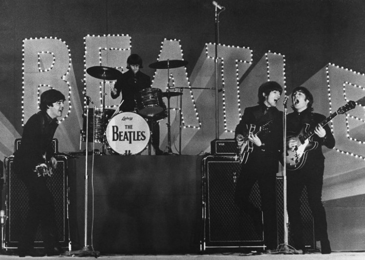 This photo taken on June 30, 1966 shows British band The Beatles, (L to R) Paul McCartney, Ringo Starr, George Harrison and John Lennon, performing during their concert at the Budokan in Tokyo.