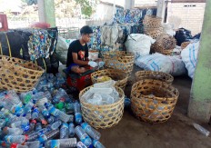 A greener future: A recycling worker separates used plastic bottles at a garbage bank in Gili Trawangan, West Nusa Tenggara.