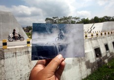 Precarious road: Cyclists pass a road covered in cold lava in Bronggang village, Sleman, Yogyakarta. JP/Boy T Harjanto