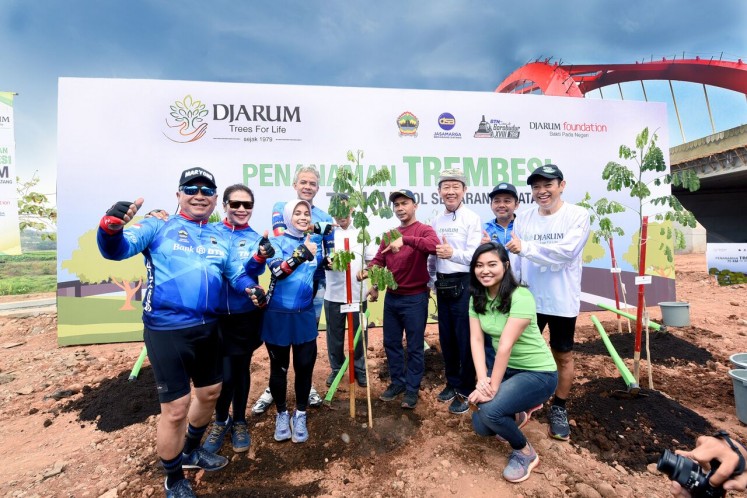 Cheers for trees: Participants of a sports tourism event called 2018 Tour de Borobudur pose together for a photograph with Central Java Governor <a href=