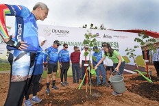 Plant the seeds: A Djarum Foundation officer (right, in green shirt) is watering the first trembesi plant that will grace the Semarang &ndash; Batang toll road as part of the foundation&rsquo;s Djarum Trans-Java Trees for Life (DTFL program) as Central Java Governor Ganjar Pranowo (left) looks on. Seeking to reduce carbon emission on toll roads with the help of the trembesi trees since 2010, all the trees planted throughout the program can absorb more than 2.7 million tons of carbon dioxide annually. 