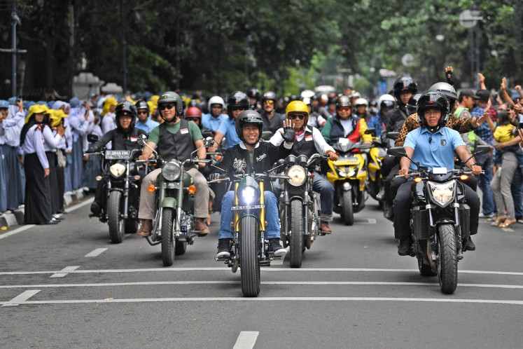 President Joko “Jokowi” Widodo (middle) rides a motorbike, along with West Java Governor Ridwan Kamil (second left) and members of a biker community during a tour across Bandung, West Java on Sunday to advocate national unity. The event was part of a movement to maintain peace and speak out against intolerance and radicalism.