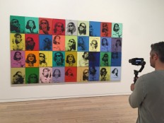 A man films the painting 'Ethel Scull 36 Times' (1963) by late US artist Andy Warhol during a press preview of the exhibition 'Andy Warhol - From A to B and Back Again' at the Whitney Museum in New York on November 6, 2018. 