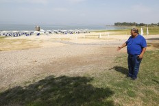 Meir Barkan, tourism director for the Ein Gev resort, shows journalists the location of the water level in in 2010, near Kibbutz Ein-Gev on the shores of the Sea of Galilee on October 8, 2018. 