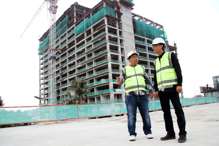 Property developer LRT City Jaticempaka-Gateway Park project director Ibnu Mahmud Junaidi (left) and Adhi Commuter Properti marketing director Djoko Santoso are pictured at the LRT City project site in Bekasi, West Java, in this file photo. The project, built near a planned light rail transit station (LRT), adheres to the principles of a transit-oriented development, such as being a high-density mixed-use area and walkable.