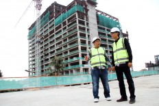 Property developer LRT City Jaticempaka-Gateway Park project director Ibnu Mahmud Junaidi (left) and Adhi Commuter Properti marketing director Djoko Santoso are pictured at the LRT City project site in Bekasi, West Java, in this file photo. The project, built near a planned light rail transit station (LRT), adheres to the principles of a transit-oriented development, such as being a high-density mixed-use area and walkable.