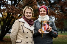 Geneva theology professors Elisabeth Parmentier (L) and Lauriane Savoy pose with an edition of 'A Women's Bible' on November 20, 2018 in Geneva. 