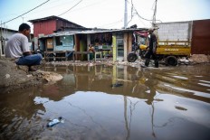 Tidal flooding hits a fishing village in Muara Angke, North Jakarta, in this file photo taken on Nov. 26, 2018. 