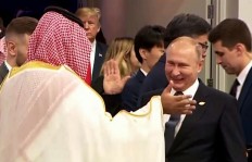 In this still image obtained from an Argentina G20 video, Russia's President Vladimir Putin (C) and Saudi Arabia's Crown Prince Mohammed bin Salman greet each other at the G20 Leaders' Summit in Buenos Aires, on November 30, 2018, as US President Donald Trump enter the room (C left rear). 
HO / G20 ARGENTINA / AFP