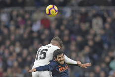Mano a mano: Valencia's Spanish midfielder Daniel Parejo (right) heads the ball while clashing with Real Madrid's Uruguayan midfielder Federico Valverde during a Spanish league soccer match between Real Madrid and Valencia at the Santiago Bernabeu stadium in Madrid on Saturday. 