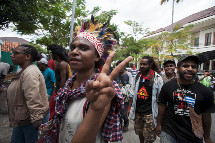 Hundreds of people march in Surabaya on Saturday under the banner of the Papuan Students Alliance (AMP).