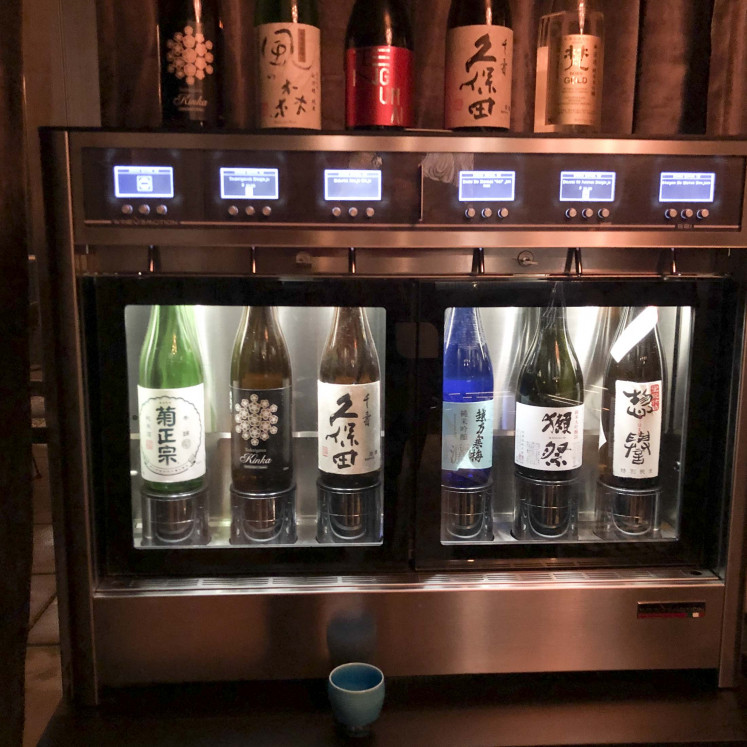 A sake-dispensing machine from Wine Emotion that features six bottles at Sushi by Bou