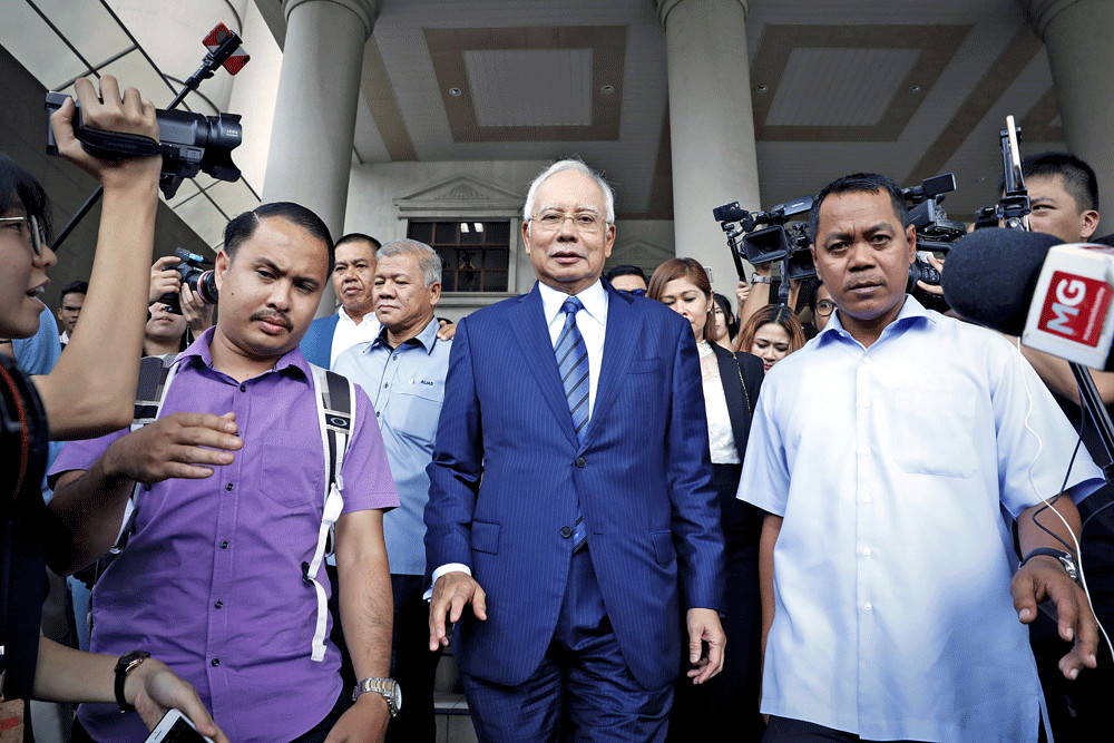 I’m back: Malaysia’s former prime minister, Najib Razak (center), leaves the Kuala Lumpur Courts Complex on Wednesday.
