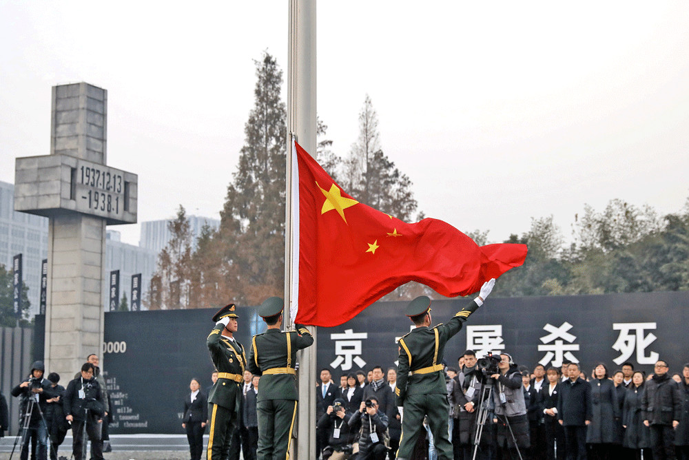 People&rsquo;s Liberation Army soldiers raise the Chinese flag during a ceremony at the Nanjing Massacre Memorial Hall to commemorate the 81st anniversary of the massacre in Nanjing in China&rsquo;s eastern Jiangsu province on Thursday. Looting, killing and rape took place for six weeks when the Imperial Japanese Army captured Nanjing on Dec. 13, 1937.