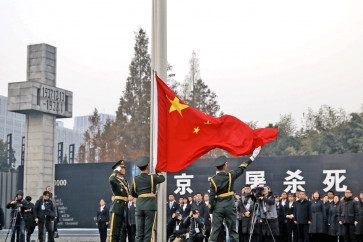 People&rsquo;s Liberation Army soldiers raise the Chinese flag during a ceremony at the Nanjing Massacre Memorial Hall to commemorate the 81st anniversary of the massacre in Nanjing in China&rsquo;s eastern Jiangsu province on Thursday. Looting, killing and rape took place for six weeks when the Imperial Japanese Army captured Nanjing on Dec. 13, 1937.