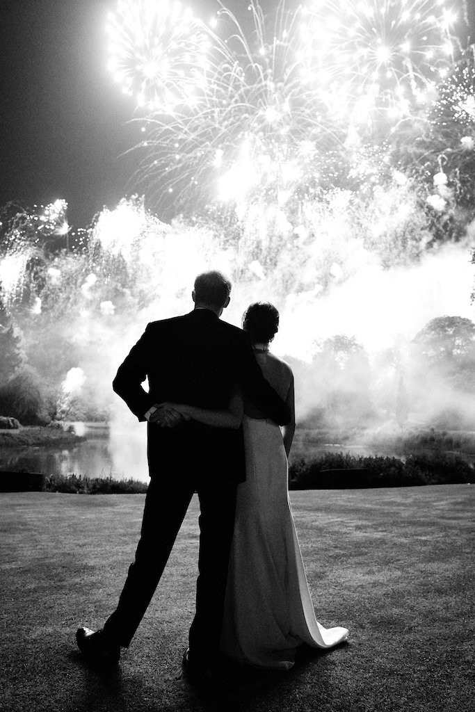 Britain's Prince Harry and the Duchess of Sussex watch a firework display at their wedding reception at Frogmore House on 19th May 2018. 