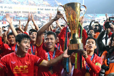 Winner takes it all: Vietnam's forward, Nguyen Anh Duc (center), and teammates hold the trophy as they celebrate after beating Malaysia in a final soccer match to win the AFF Suzuki Cup 2018 at My Dinh Stadium in Hanoi on Saturday. 