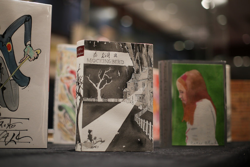 A first edition of Lee Harper's book 'To Kill a Mockingbird' (C) with a dust-jacket designed by George Butler is seen on display at Sotheby's action house in London on Dec. 7, 2017 during a exhibition to promote the 'First Editions Re-Covered' auction sale to benefit Quentin Blake’s Charity, House of Illustration.