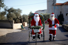 Racing Santas bring Christmas cheer to Israeli village