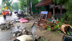 Debris from damaged buildings is seen on a street on Carita beach on December 23, 2018, after the area was hit by a tsunami on December 22 that was triggered by an eruption of the Anak Krakatoa volcano. - A tsunami triggered by a volcanic eruption killed 43 people and injured hundreds more as it slammed without warning into tourist beaches and coastal areas around Indonesia's Sunda Strait on the night of December 22, sending panicked holiday makers and residents fleeing. 