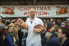 Butchers auction off cuts of meat during the traditional pre-Christmas meat auction at Smithfield market in the city of London on December 24, 2018. 