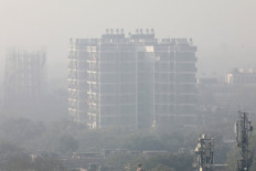 A residential building is shrouded in smog in New Delhi, India, December 25, 2018. 