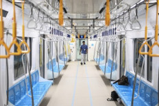 An official from MRT Jakarta walks inside an empty train on Dec. 10, 2018.