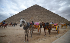 Tourists throng Egypt pyramids after bombing, but future clouded