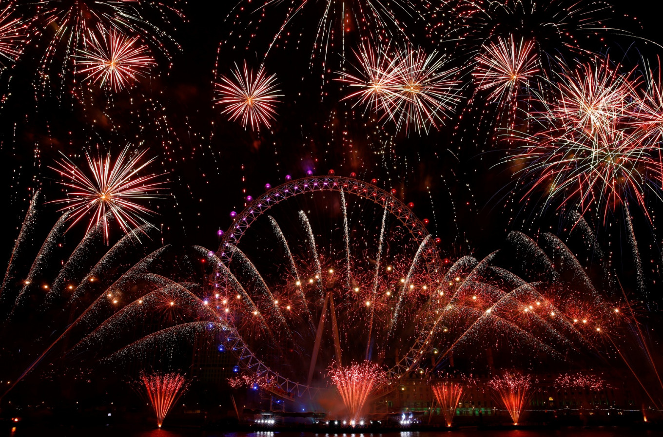 Fireworks explode around the London Eye during New Year's celebrations in central London just after midnight on January 1, 2019. 