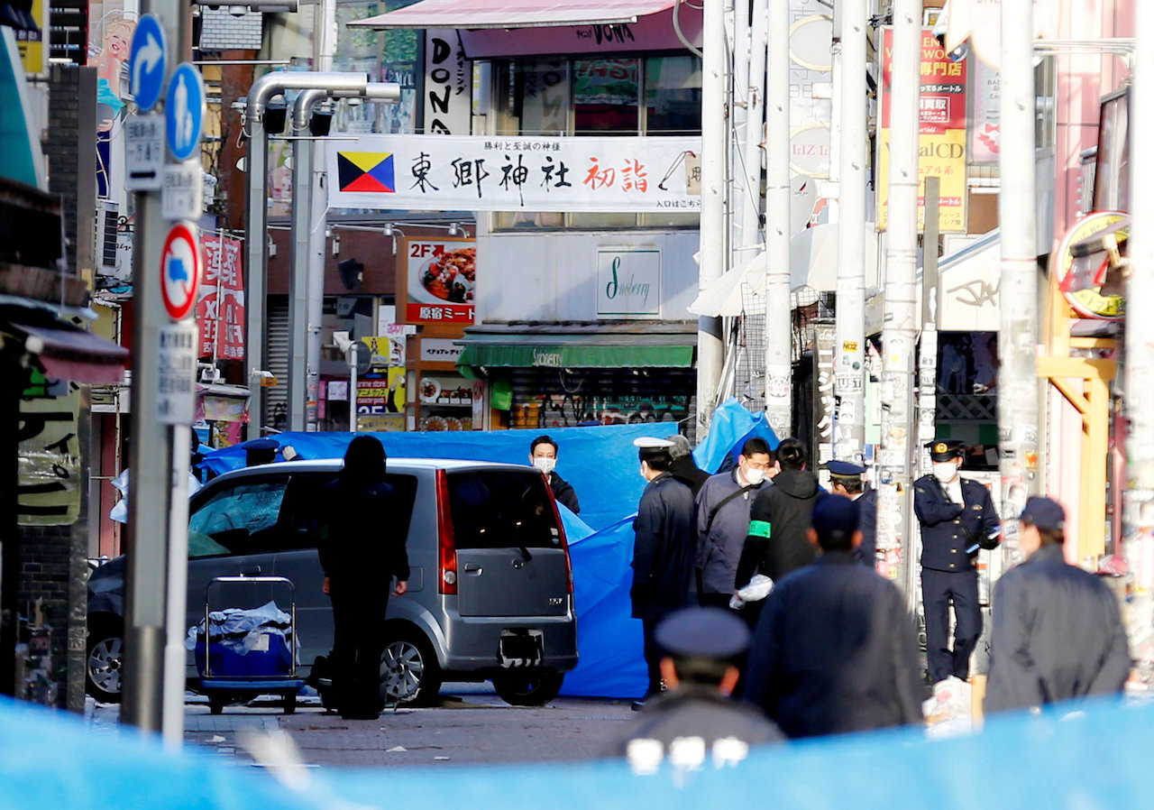 Policemen stand next to a car which plowed into pedestrians on New Year day in Tokyo, Japan, January 1, 2019. 