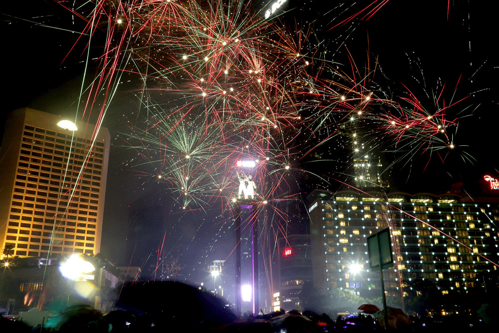 Fireworks light up the Jakarta sky as revelers celebrate New Year’s Eve at the Hotel Indonesia traffic circle on Dec. 31, 2018.