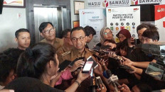 Jakarta Governor Anies Baswedan speaks to reporters at the Elections Supervisory Agency (Bawaslu) in Jakarta on Jan. 7.
