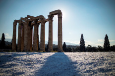 Winter sun: This picture taken on Tuesday in Athens shows the archaeological site of the ancient Temple of Zeus following snowfall over the Greek capital.
