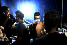 Get ready: Oriental Circus Indonesia performers put on make up and face paint before their performance. JP/Dhoni Setiawan