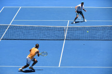 Spain's Rafael Nadal (left) hits a return against Australia's James Duckworth during their men's singles match on day one of the Australian Open tennis tournament in Melbourne on January 14, 2019. 
