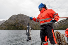 Marine biologist Marco Pinto holds a conductivity, temperature, and depth measurement instrument (CTD), during research in Seno Ballena fjord at Santa Ines island in Punta Arenas, Magallanes region, southern Chile on December 7, 2018. 