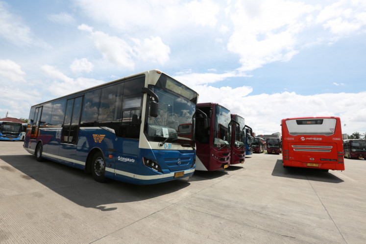 An older model Transjakarta bus parks among newer ones at the depot in Cawang, East Jakarta, on Jan. 2. For better or worse, the busway has changed the way Jakartans see buses.