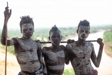 Group of three young Karo Tribesman with bodypaintings in Kolcho, Ethopia