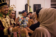 The groom, Kusumo Bimantoro, and the bride, Maya Lakshita Noorya, greet guests. JP/Anggertimur Lanang Tinarbuko