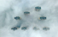 This aerial view shows the tops of highrise buildings poking out from heavy fog in Yangzhou, in China's eastern Jiangsu province on January 14, 2019. Authorities in the city issued a fog alert with heavy fog reducing visibility to 50 meters.