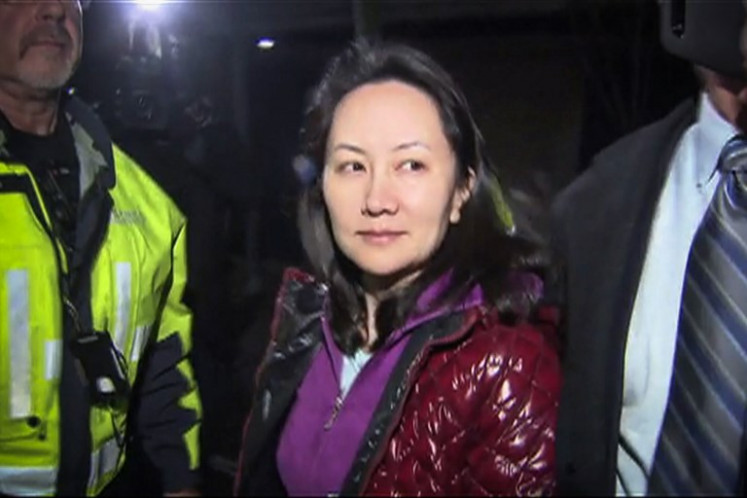 This TV image provided by CTV to AFP shows Huawei Technologies Chief Financial Officer Meng Wanzhou as she exits the court registry following the bail hearing at British Columbia Superior Courts in Vancouver, British Columbia on December 11, 2018. Meng Wanzhou, the chief financial officer of Huawei, was released on Can$10 million (US$7.5 million) bail on Tuesday in a case that has rattled relations between China, the United States and Canada.
